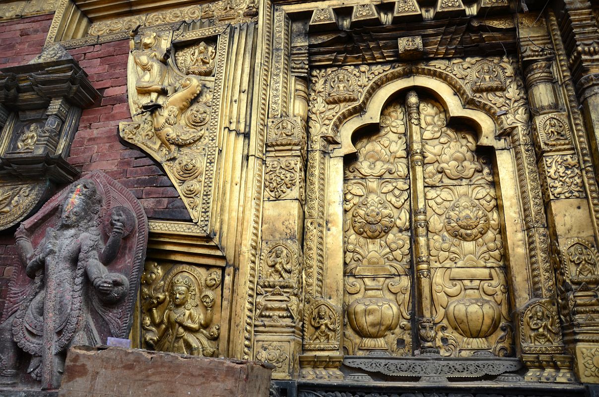 Kathmandu Changu Narayan 19 Gilded Window And Ornate Carvings On Left Side Of Main Entrance To Changu Narayan Temple The left side of the main entrance to the Changu Narayan Temple has a gilded window and ornate carvings.